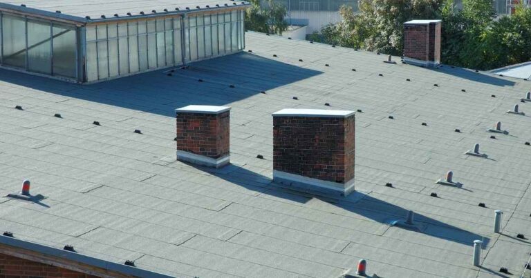 Flat roof design with built-up roofing layers on a commercial facility