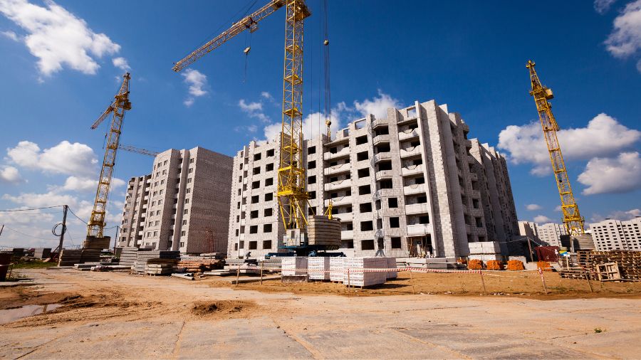 Contractors reviewing blueprints for a commercial construction project